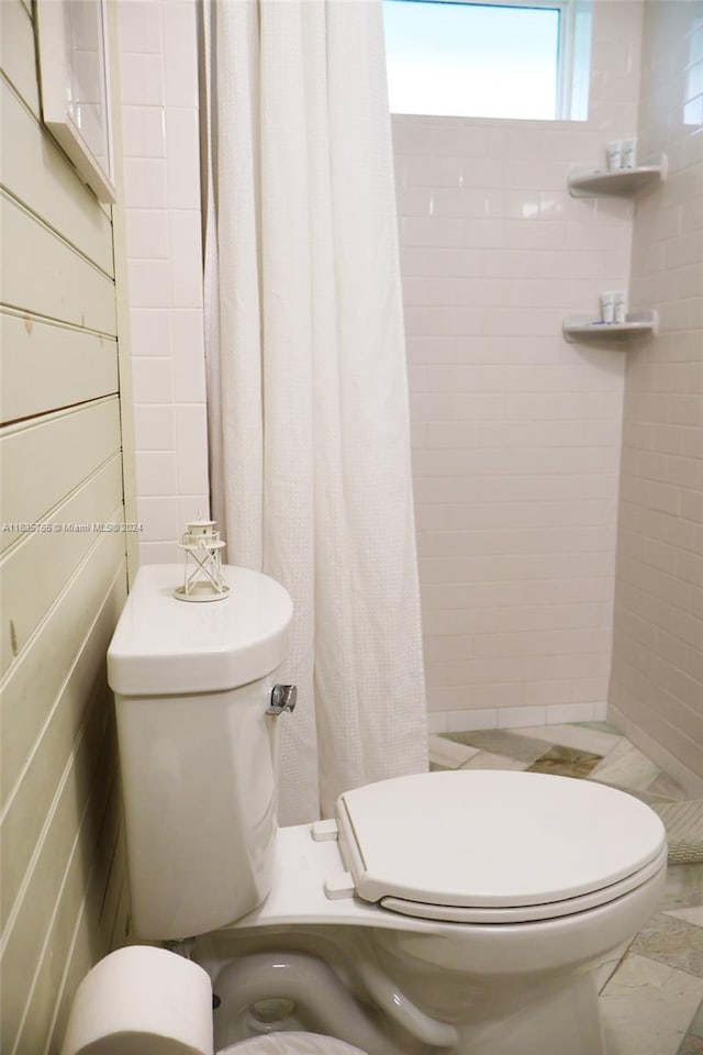 bathroom with wooden walls and vanity