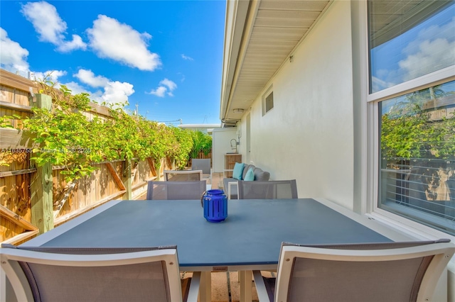 view of patio / terrace featuring outdoor dining area and fence