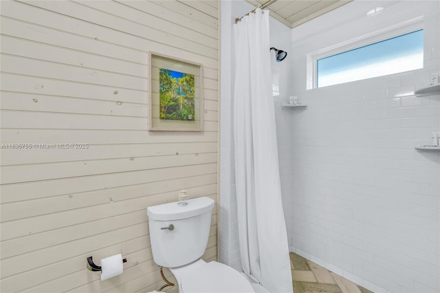 full bathroom featuring a stall shower and toilet