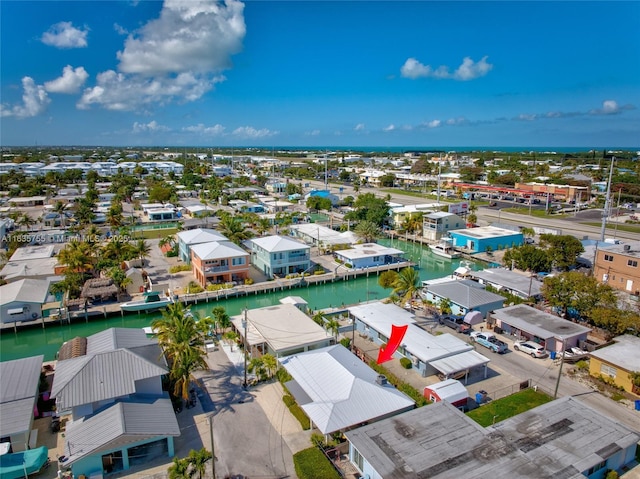 birds eye view of property with a water view and a residential view