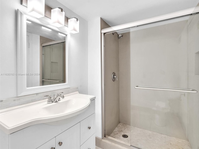 bathroom featuring a shower stall and vanity