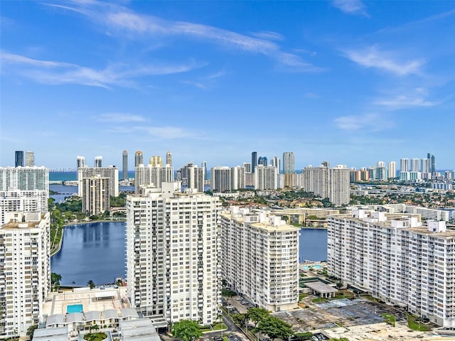 birds eye view of property featuring a water view and a view of city