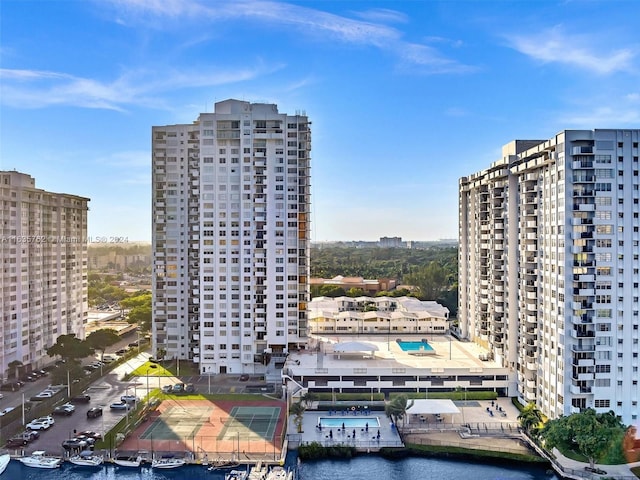 view of building exterior with a view of city and a water view