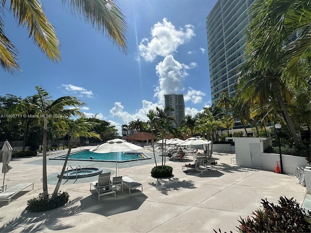 view of swimming pool with a community hot tub and a patio