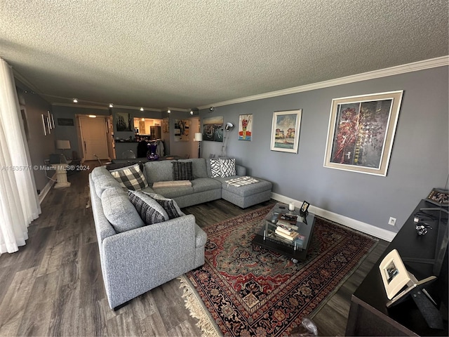 living room with a textured ceiling, ornamental molding, and dark wood-type flooring