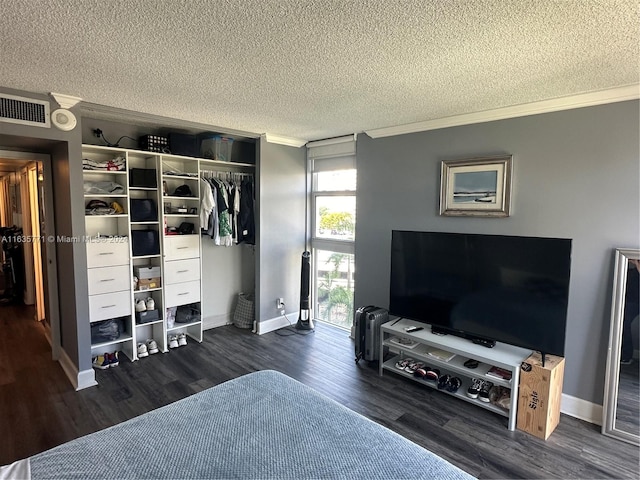 living room with a textured ceiling, crown molding, and wood-type flooring