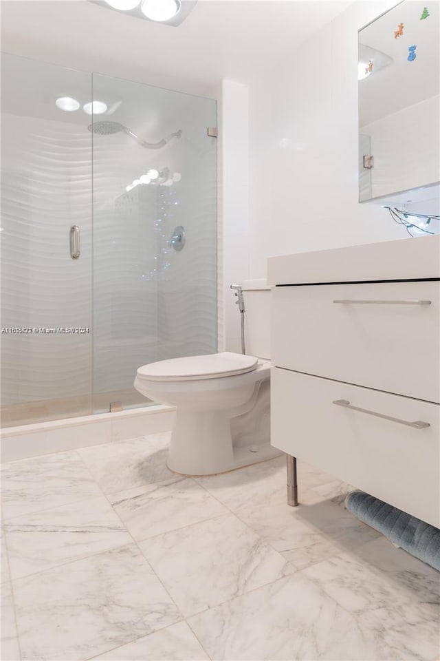 bathroom with vanity, toilet, tile patterned flooring, and a shower with shower door