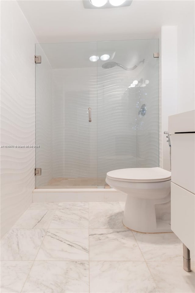 bathroom with toilet, tile patterned floors, and an enclosed shower