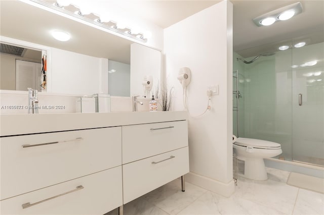 bathroom with vanity, toilet, tile patterned flooring, and a shower with shower door