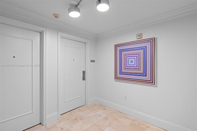 tiled spare room featuring ornamental molding