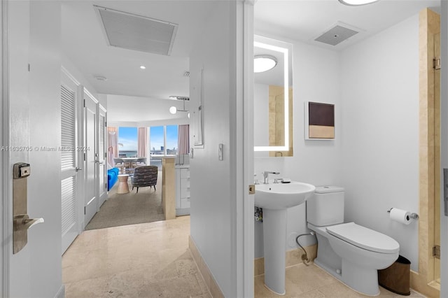 bathroom featuring tile patterned flooring, toilet, and sink