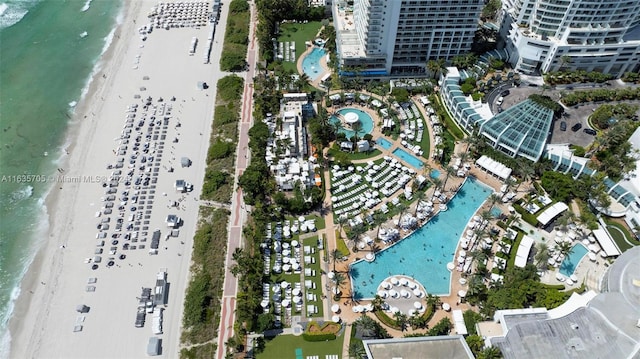 drone / aerial view with a water view and a beach view