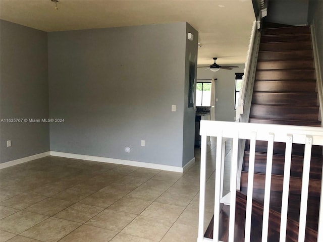 stairs with light tile patterned flooring and ceiling fan