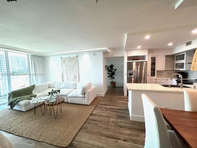 living room featuring dark hardwood / wood-style flooring and sink