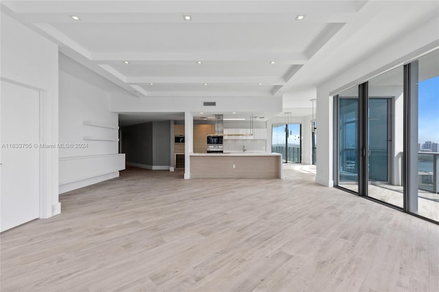 unfurnished living room with visible vents, baseboards, beamed ceiling, light wood-type flooring, and recessed lighting