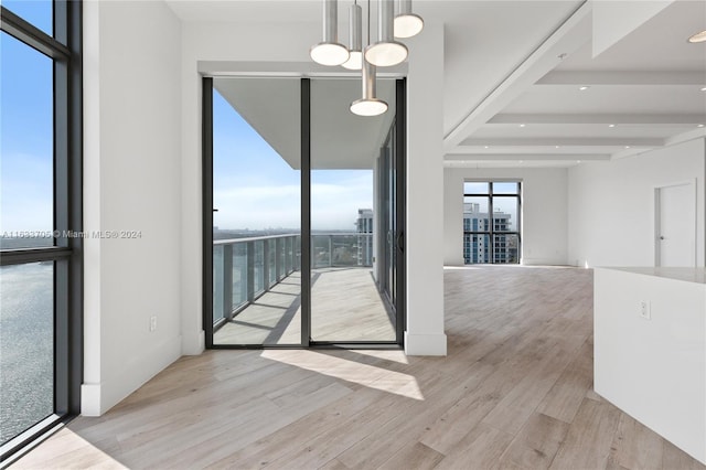 spare room featuring baseboards and light wood-style floors