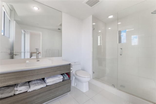 full bathroom featuring tile patterned flooring, toilet, vanity, visible vents, and a shower stall