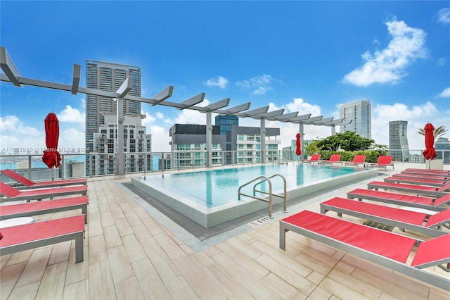 community pool with a view of city and a pergola