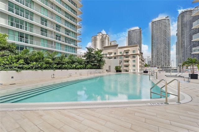 pool featuring a patio area and a city view