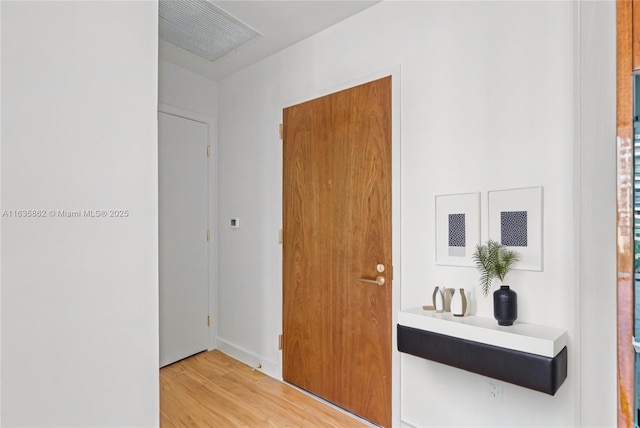 corridor with hardwood / wood-style flooring