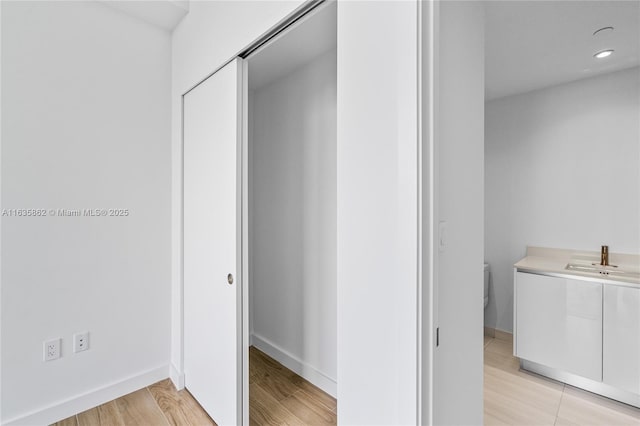 bathroom featuring hardwood / wood-style flooring, vanity, and toilet