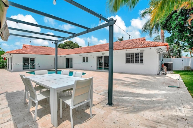 rear view of property featuring a patio area and a yard