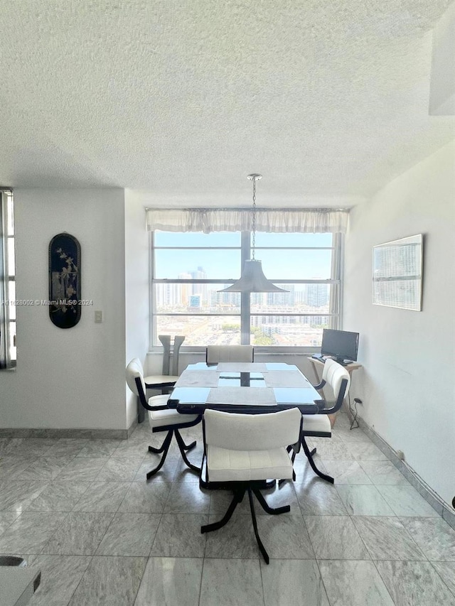 dining space with a textured ceiling