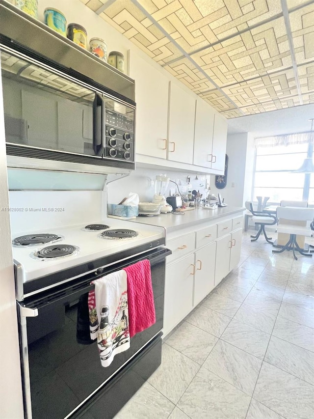 kitchen with white cabinetry and white range with electric cooktop