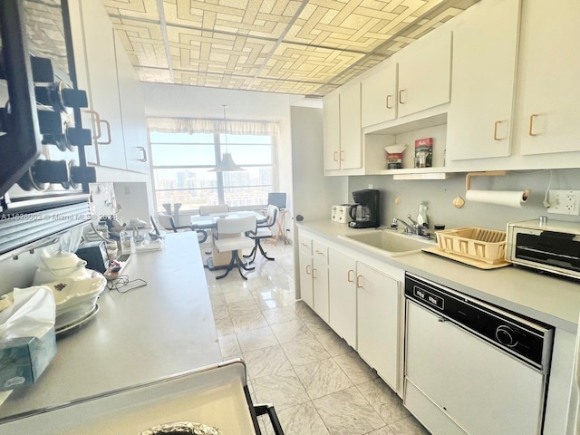 kitchen with white cabinetry, dishwasher, and sink