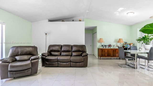 tiled living room featuring vaulted ceiling