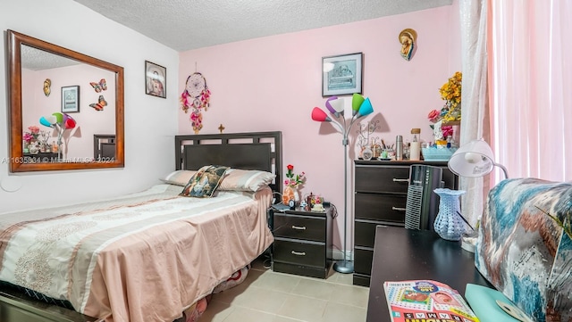 bedroom with light tile patterned flooring and a textured ceiling