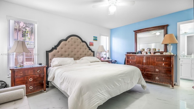 bedroom featuring multiple windows, ensuite bathroom, light tile patterned floors, and ceiling fan