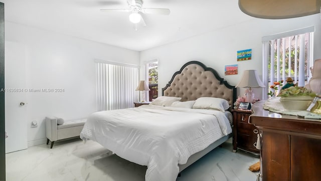 bedroom featuring multiple windows and ceiling fan