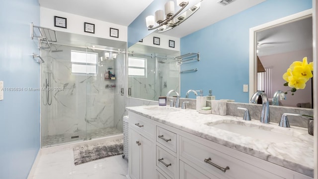 bathroom with tile patterned flooring, double sink vanity, a shower with door, and ceiling fan