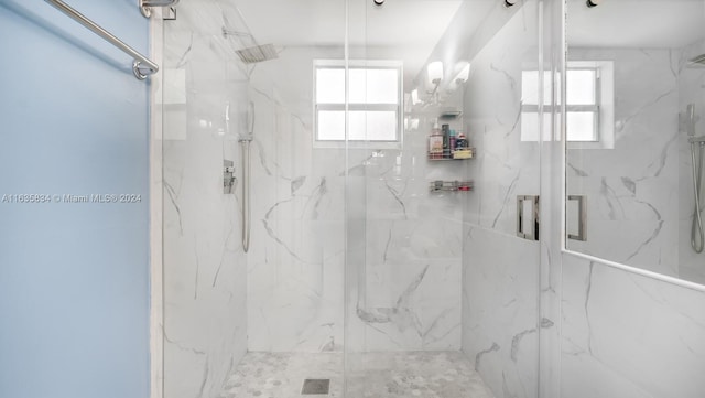 bathroom featuring a shower with door