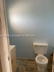 bathroom featuring vanity, tile patterned flooring, and toilet