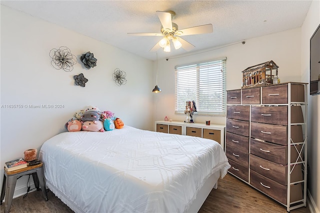 bedroom featuring ceiling fan, a textured ceiling, and dark hardwood / wood-style flooring