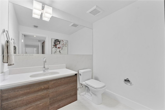 bathroom featuring toilet and vanity