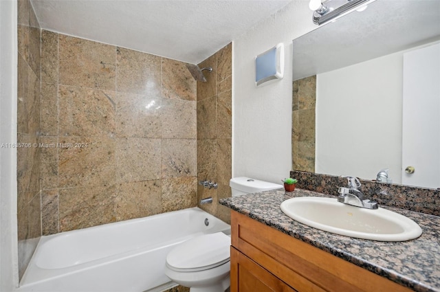 full bathroom featuring vanity, a textured ceiling, toilet, and tiled shower / bath combo