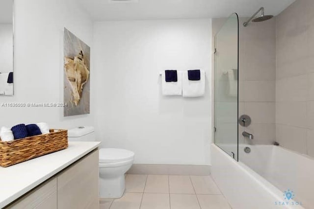 full bathroom with vanity, toilet, combined bath / shower with glass door, and tile patterned flooring