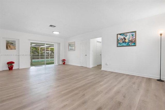 unfurnished room with light wood-type flooring