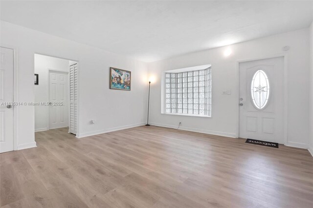 unfurnished living room featuring light wood-type flooring