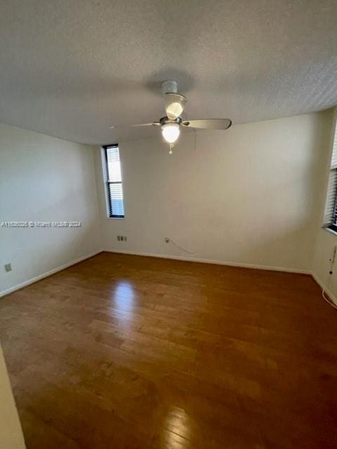 spare room featuring ceiling fan, a textured ceiling, and hardwood / wood-style floors