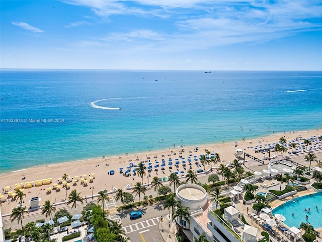 bird's eye view with a water view and a beach view