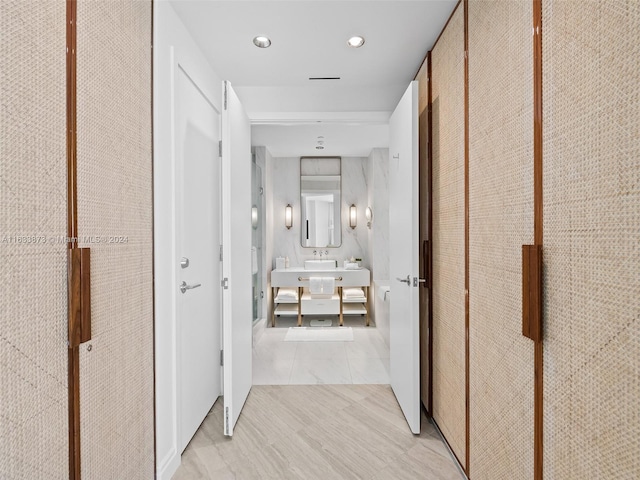 corridor with light hardwood / wood-style floors