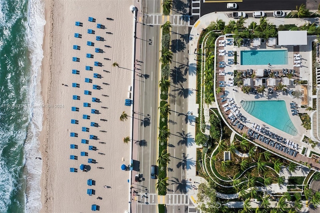 aerial view with a water view and a beach view