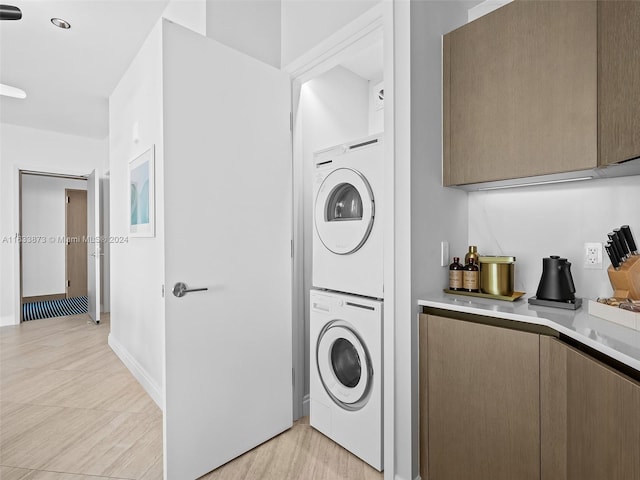 washroom featuring light wood-type flooring and stacked washer and dryer