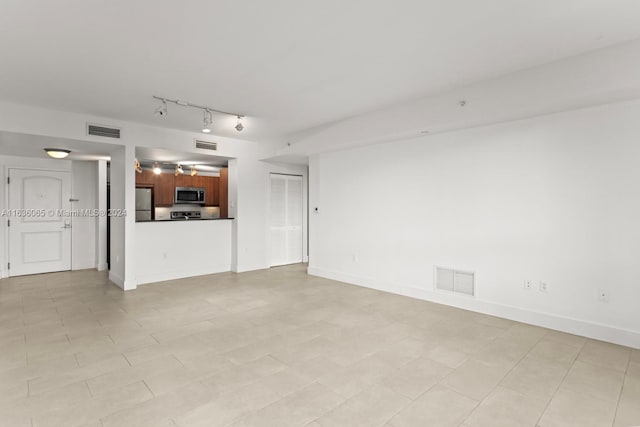 unfurnished living room featuring light tile patterned floors