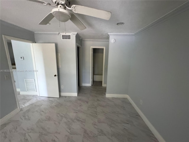 unfurnished bedroom with ornamental molding, tile patterned floors, a textured ceiling, and ceiling fan