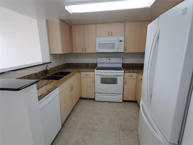 kitchen with white appliances, sink, light brown cabinets, and light tile patterned floors